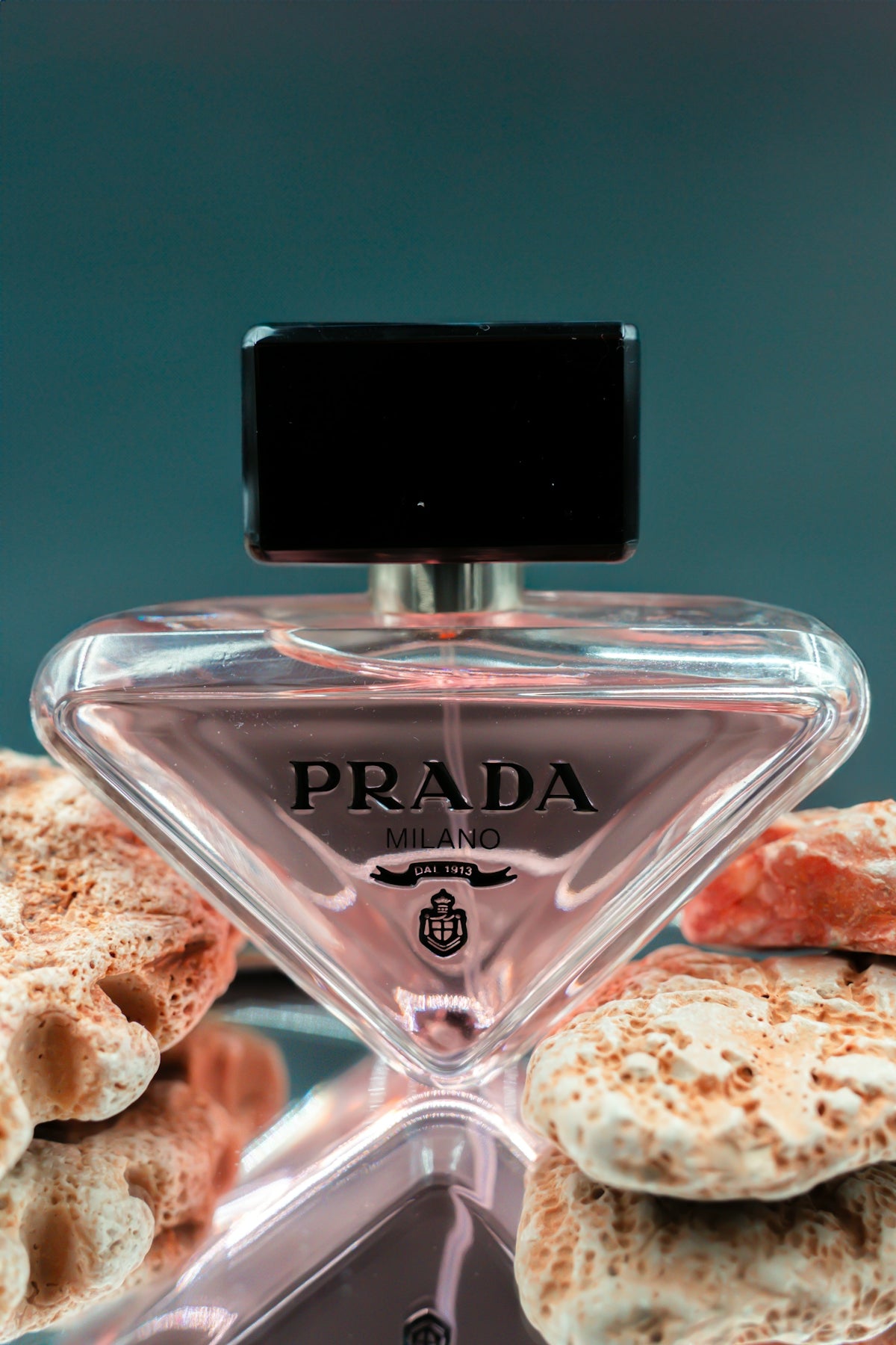 a bottle of prada perfume sitting on top of a table