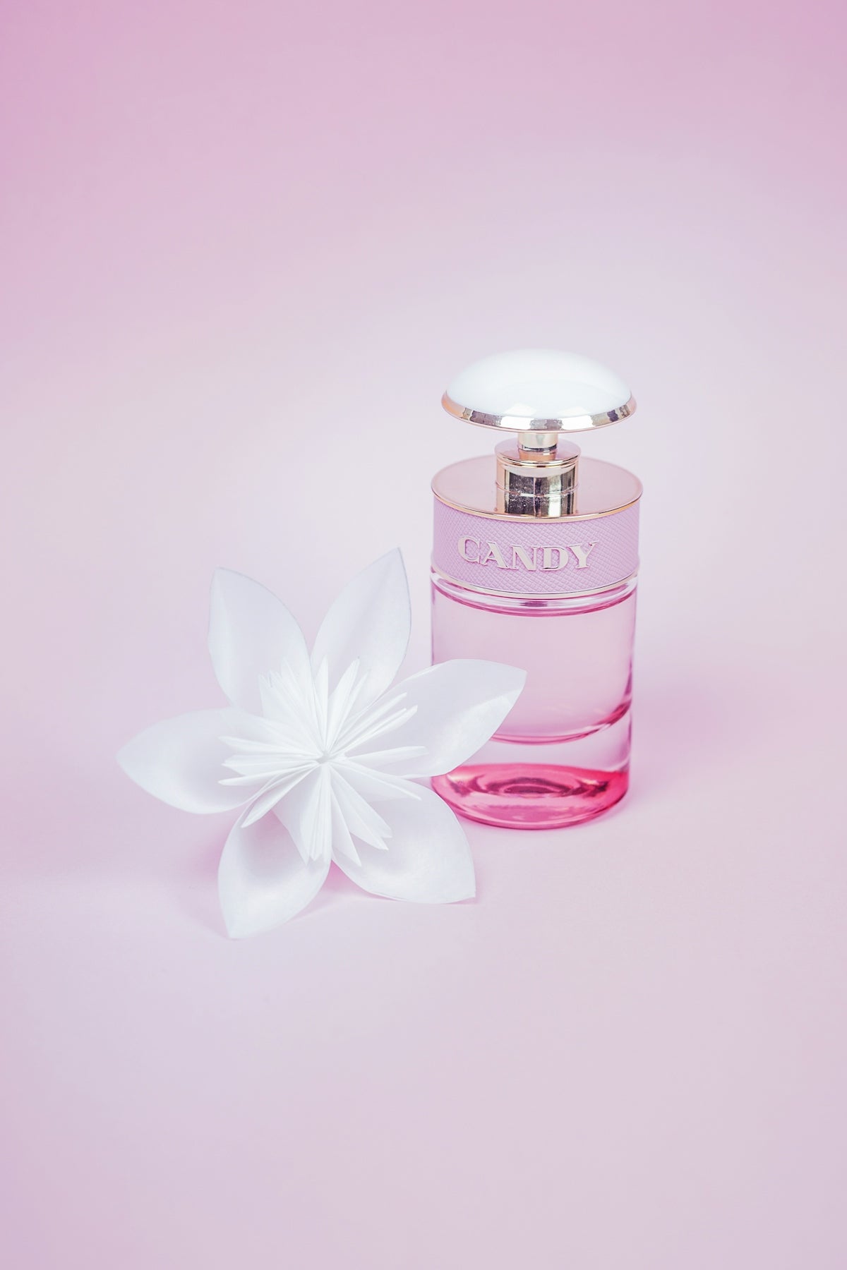 pink perfume bottle with white flower